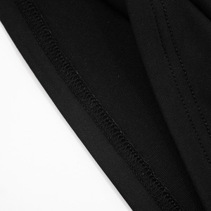 Detail of the high-quality overlock stitching on a black knitted off-shoulder top