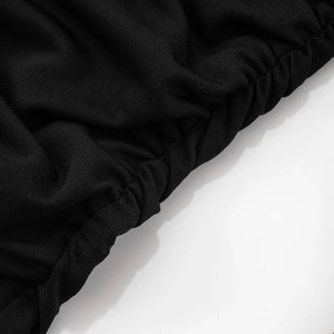 Close-up of black knitted fabric texture with elegant ruched design and elastic finish