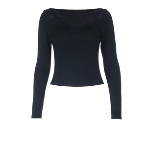 Detail of the V-neckline featuring delicate black lace trim on a slim fit long sleeve top
