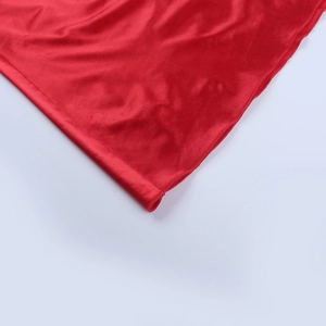 Detail of red satin dress featuring high-quality rolled hem stitching and glossy silk texture