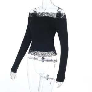 Detail of off-shoulder black ribbed knit top with delicate lace trim on hem and neckline