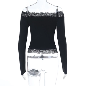 Detail of elegant black off-shoulder top with long sleeves and delicate lace trim