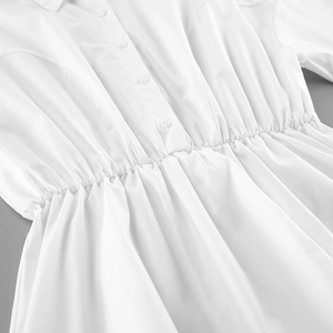 Detail view of cotton white shirt with waist pleats and single-breasted button design