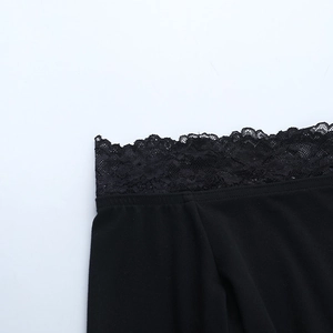 Close-up of elegant black floral lace trim and textured fabric on a Y2K bodycon dress