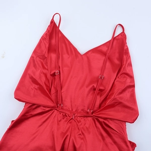 Detail of red satin dress back with adjustable straps and invisible zipper closure
