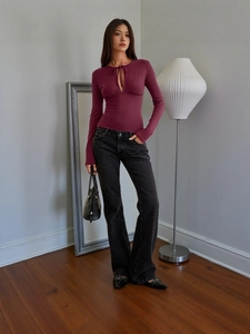 Slim fit burgundy long sleeve t-shirt with cutout tie neck and black flared jeans