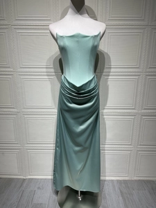 Close-up of mint green strapless evening gown featuring structured corset and silk satin texture