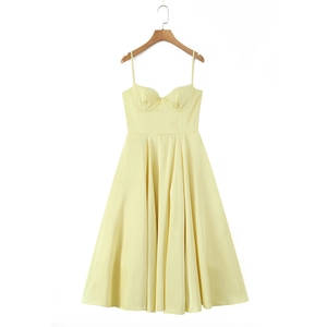 Detail of elegant pale yellow midi dress featuring sheer tulle and supportive bustier cups
