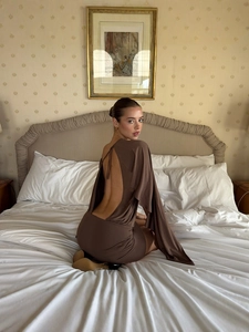 Deep brown backless puff dress with long sleeves in a vintage bedroom setting