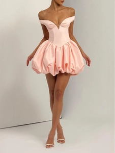 Detailed close-up of a pink off-the-shoulder dress with a stylish bubble hem and satin finish