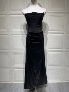 Detail of elegant black strapless floor-length gown with ruched bodice and subtle shimmer