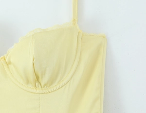 Close-up of the light yellow satin dress with lace trim and underwire cups