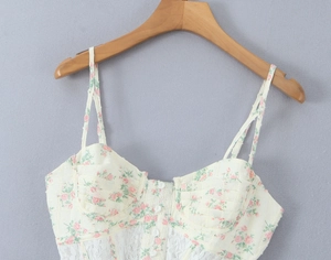 Détail de caraco à fleurs montrant des bonnets corset avec dentelle délicate et boutons