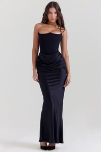 Detail of elegant black corset dress with gathered waist folds and satin finish skirt