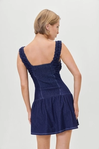 Detail view of the elastic smocked back and square neck on the blue denim dress