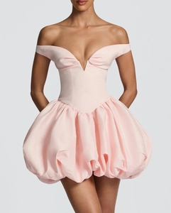 Detailed close-up of light pink off-shoulder bubble dress with sleek matte silk texture
