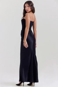 Detail of elegant black strapless evening dress with shimmering satin and mermaid hemline