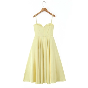 Detail view of a pale yellow slip dress featuring a sweetheart neckline and pleated waistline