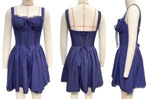 Detail of dark purple mini dress featuring lace trim and vintage lace-up back design