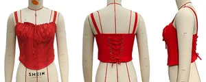 Detail of red lace-up corset top showing the front lace trim and back adjustable ties