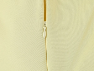 Detail shot of a seamless invisible zipper on a pale yellow French vintage tulle dress