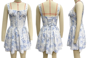 Detailed view of floral sundress featuring lace hem and corset lace-up back design