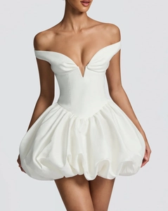 Detail of white strapless bubble dress featuring a deep V-neck and satin corset waist