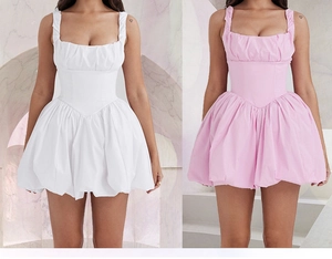 Detail of corset-style waist and puffy skirt on white and pink summer dresses