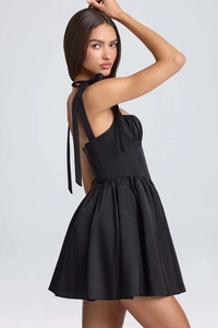 Detail of elegant black corset dress with shoulder ribbon ties and cross back lacing
