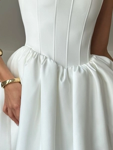 Elegant white strapless puff dress featuring corset boning and pleated high-waist detail
