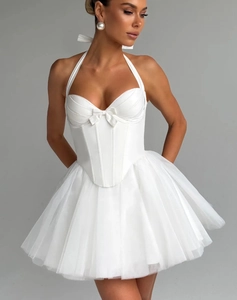 Detailed close-up of a white corset-style mini dress with halter neck and tulle skirt