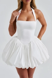 Detail of white halter neck mini dress featuring a structured corset top and puff bubble hem