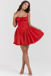 Detailed corset-style bodice with lace trim and red bow on a summer mini dress