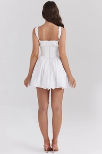 Detail of white backless mini dress with hidden back zipper and puffy bubble hemline