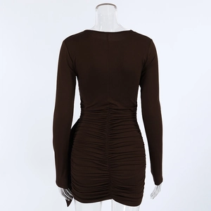 Detail view of ruched back texture on slim fit dark brown long sleeve mini dress