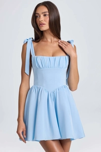 Detailed close-up of square neck corset bodice with pleated detail on light blue summer dress
