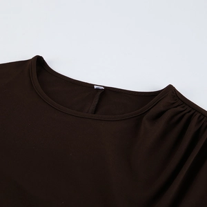Detail of round neckline and ruched shoulder on dark brown long sleeve dress
