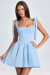 Detail of baby blue square neck dress featuring pleated bodice and bow tie straps