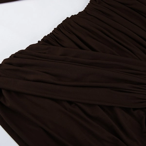 Detailed close-up of dark brown ruched fabric showing elegant pleated texture and layering