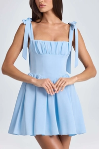 Close-up of baby blue dress featuring ruched bust detail and delicate shoulder bows
