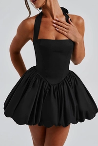 Detail of corset-style black halter neck dress with pleated bubble skirt and wide ties