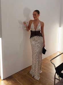 Detail of polka dot maxi dress with lace cut-out waist and halter neck design