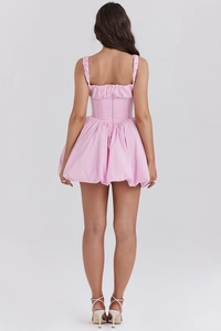 Rear view detail of a pink summer mini dress featuring a zipper and pleated puff skirt