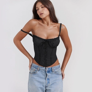 Detail of black lace corset top featuring bone framing and front drawstring ribbon