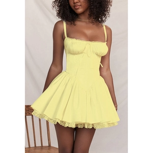 Close-up of light yellow mini dress featuring corset bodice and delicate lace trim details