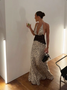 Close-up of cream halter dress featuring black lace patchwork and elegant polka dots