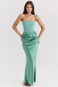 Detail of elegant bean green satin corset dress with draped skirt and floor-length hem