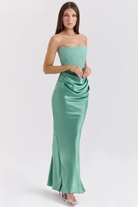 Detail view of the elegant mint green corset bodice and pleated satin evening dress