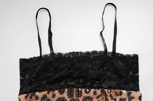 Close-up of leopard print fabric with lace trim and shimmering sequins detail