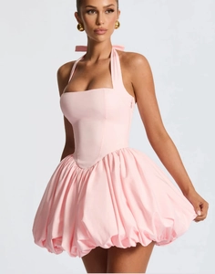 Detail view of pink halter neck dress with corseted waist and voluminous bubble skirt